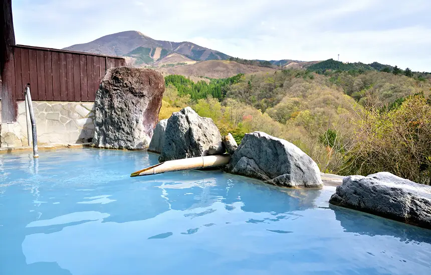 An open-air hot spring bath with a magnificent natural backdrop.