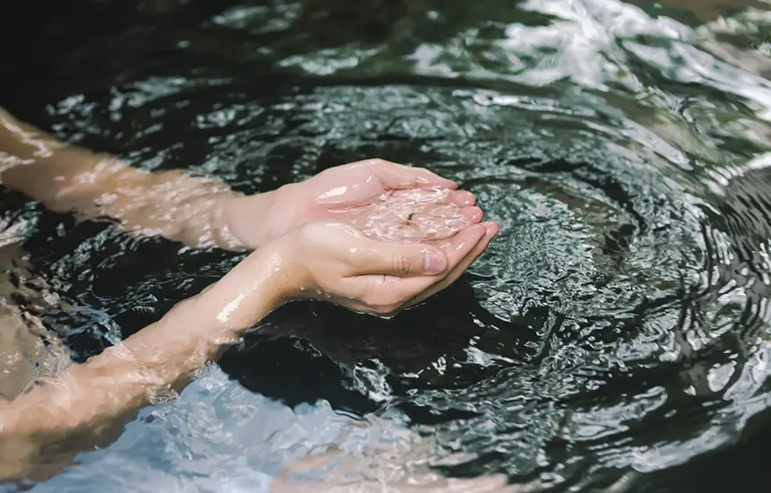 Hands Scooping Up Steaming Onsen Water