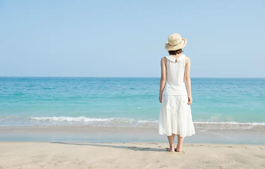 Person Walking Barefoot on a Calm Beach