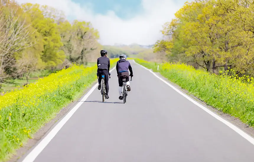 A person cycling on a beautiful Kyushu cycling road