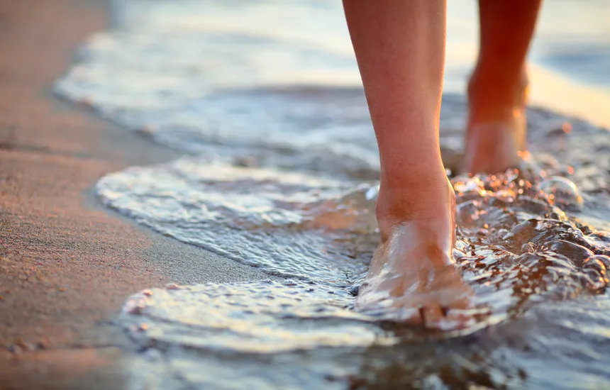 People walking on a sandy beach.
