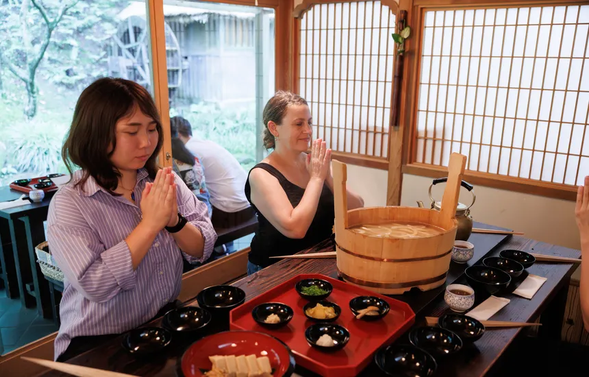 A quiet temple dining hall with a view of a tranquil garden.
