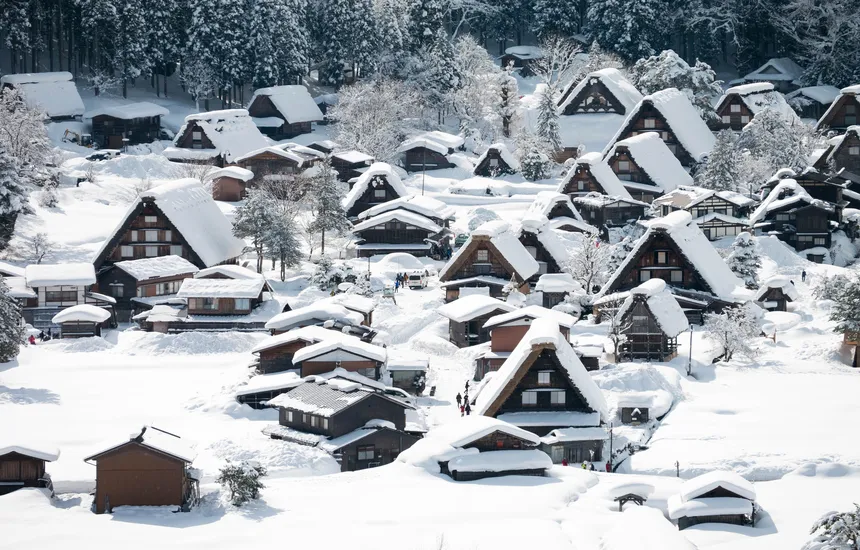 Gassho-zukuri villages covered in snow in Shirakawa-go, with warm lights glowing at night.